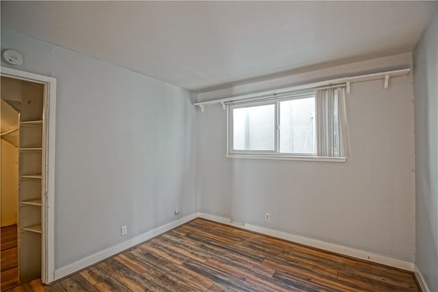 empty room with dark wood-type flooring