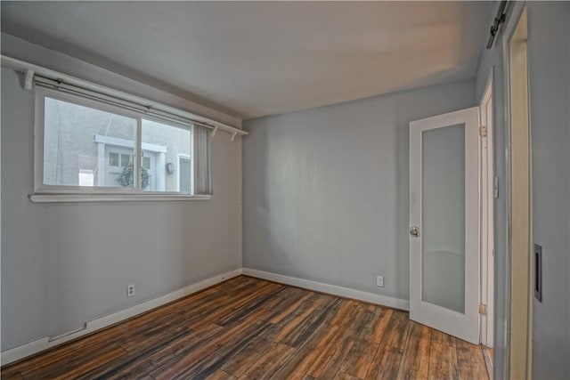 unfurnished room featuring dark wood-type flooring