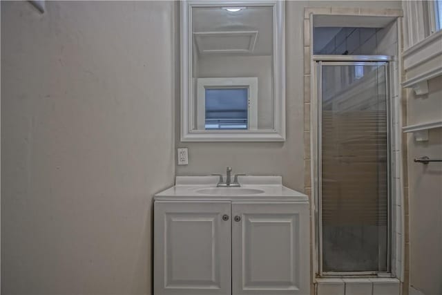 bathroom with vanity and a shower with shower door