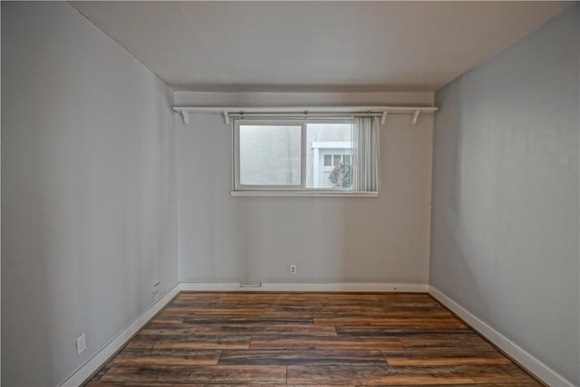 spare room with dark hardwood / wood-style flooring