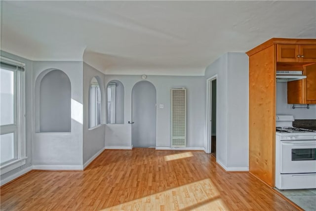 interior space featuring light hardwood / wood-style floors and white range with gas stovetop