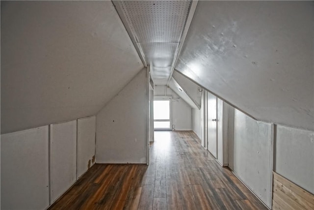 additional living space featuring lofted ceiling and dark hardwood / wood-style floors