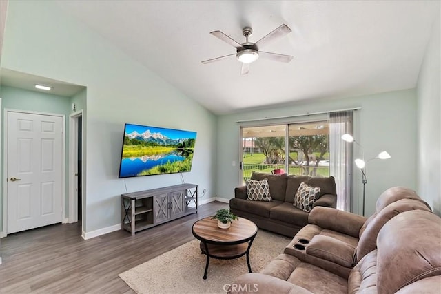 living room featuring hardwood / wood-style flooring, ceiling fan, and high vaulted ceiling