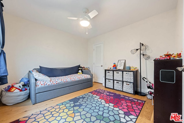 bedroom with hardwood / wood-style floors and ceiling fan