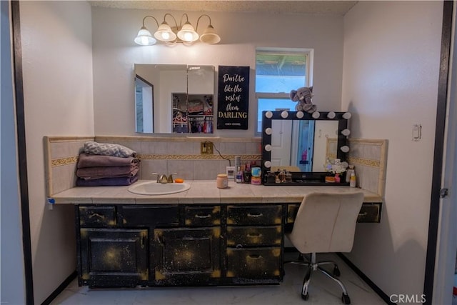 bathroom featuring vanity and backsplash