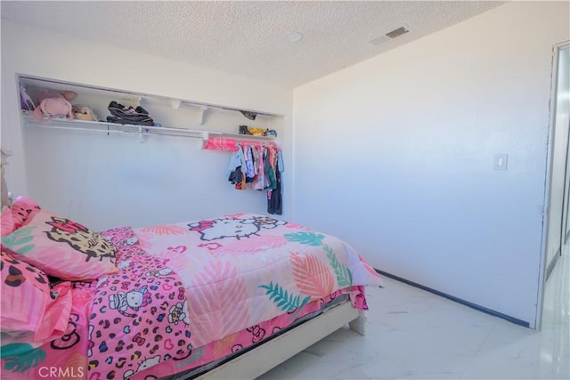 bedroom with a closet and a textured ceiling