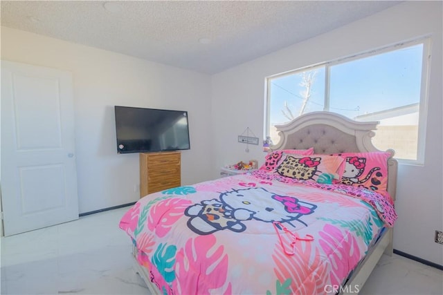 bedroom featuring multiple windows and a textured ceiling