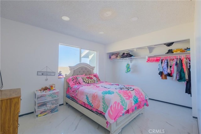 bedroom with a closet and a textured ceiling