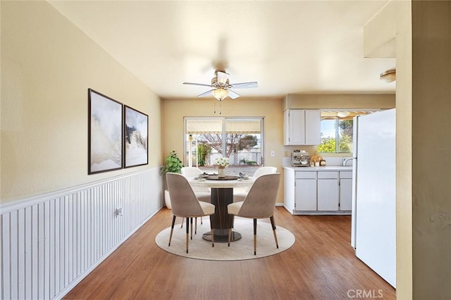 dining area featuring ceiling fan and light hardwood / wood-style flooring