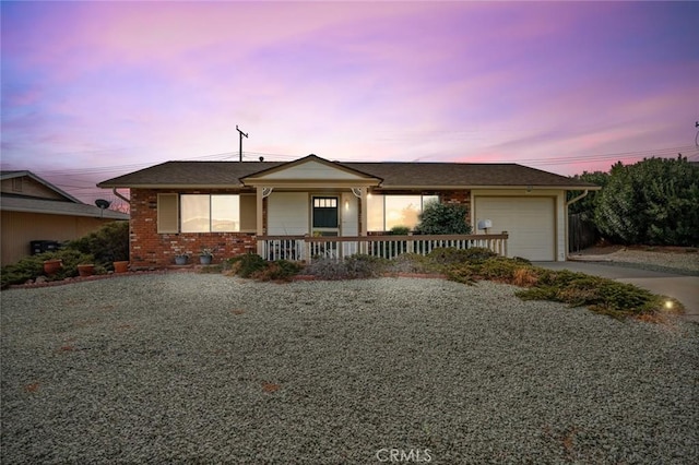 single story home with a garage and a porch