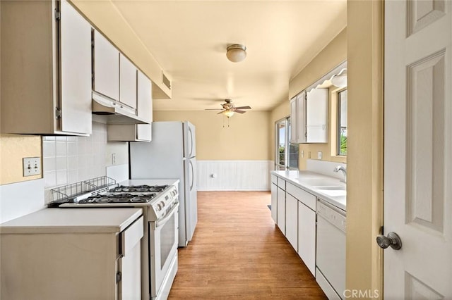 kitchen featuring sink, white cabinets, ceiling fan, light hardwood / wood-style floors, and white appliances