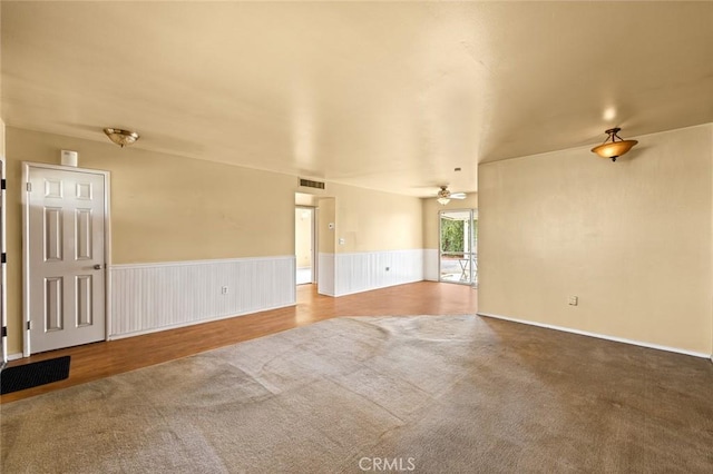 carpeted empty room with ceiling fan