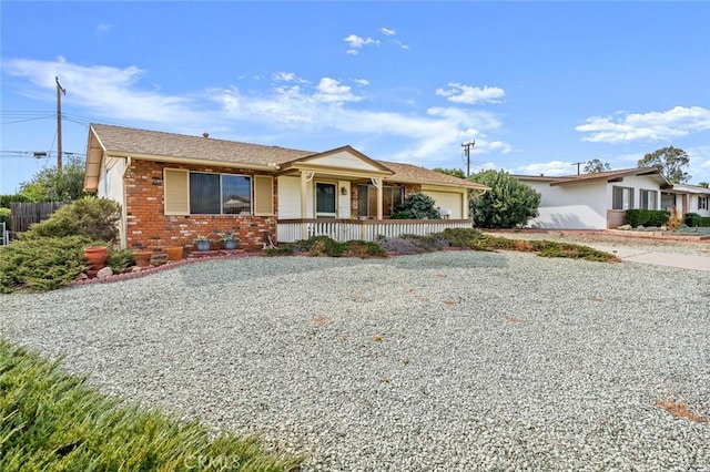 single story home with a garage and covered porch