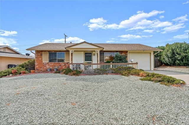 single story home featuring a garage and a porch