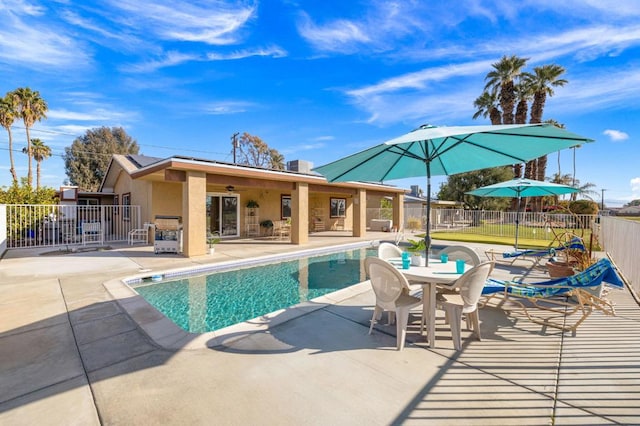 view of swimming pool featuring a patio area and ceiling fan