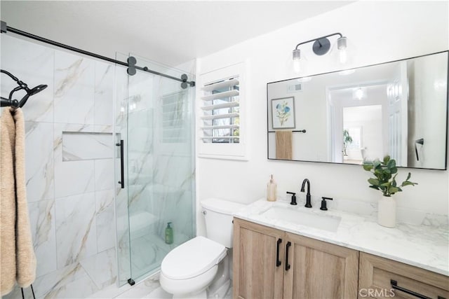 bathroom with vanity, toilet, and a shower with shower door