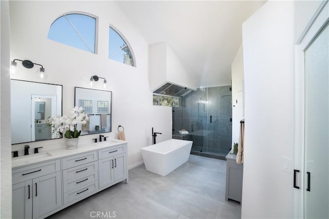 bathroom featuring vanity, separate shower and tub, and high vaulted ceiling