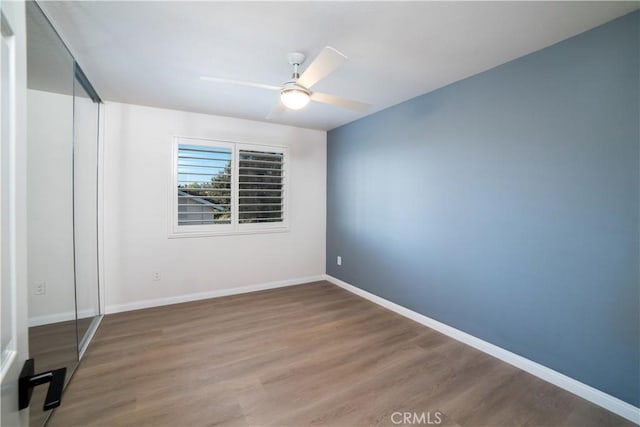 unfurnished bedroom featuring hardwood / wood-style floors and ceiling fan