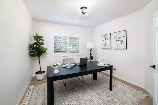 home office with hardwood / wood-style flooring