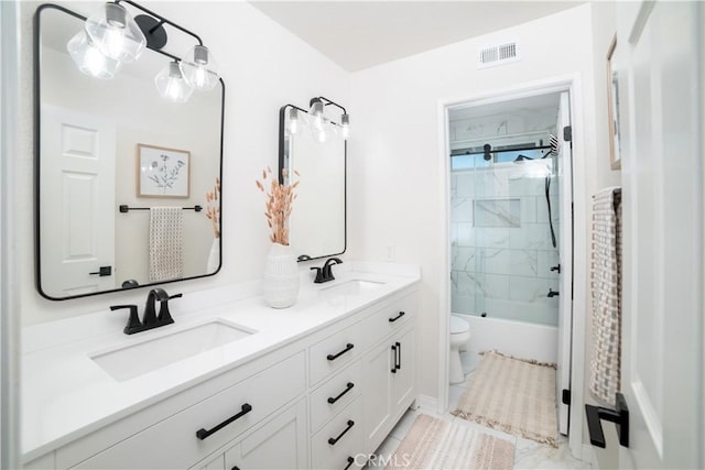 full bathroom with vanity, toilet, and tiled shower / bath