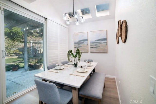 dining room with hardwood / wood-style flooring and a chandelier