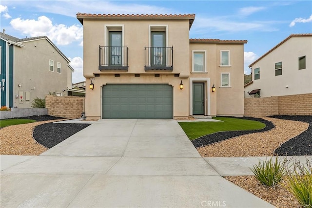 mediterranean / spanish-style home featuring a garage, concrete driveway, a balcony, and stucco siding