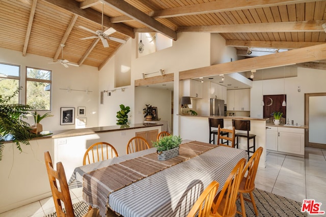 tiled dining space featuring beam ceiling, wood ceiling, and high vaulted ceiling