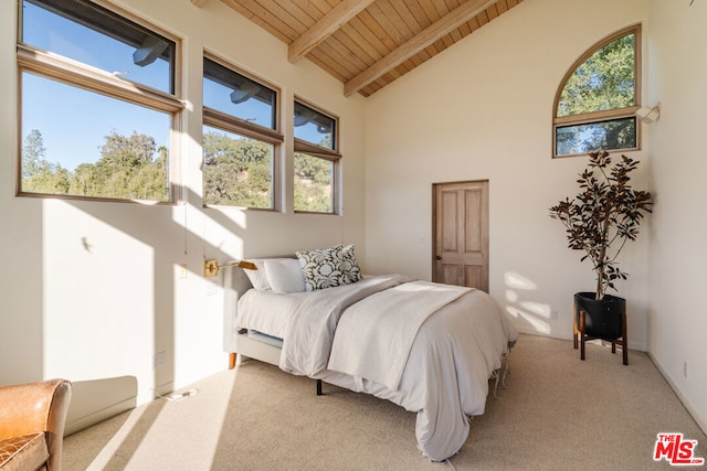 carpeted bedroom featuring beam ceiling, wood ceiling, and high vaulted ceiling