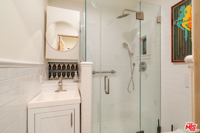 bathroom featuring vanity, tile walls, and an enclosed shower