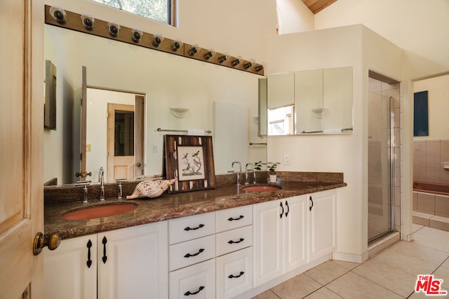 bathroom with vanity, a shower with shower door, and tile patterned flooring