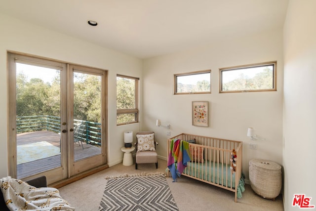 bedroom with light carpet and access to outside