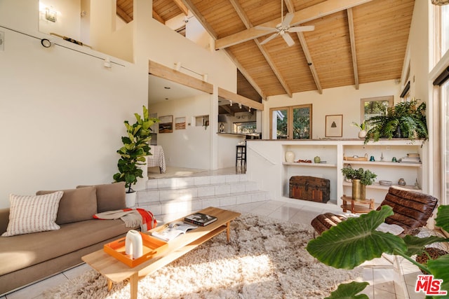 tiled living room featuring beam ceiling, high vaulted ceiling, wooden ceiling, and ceiling fan