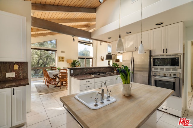 kitchen with stainless steel appliances, white cabinetry, and sink