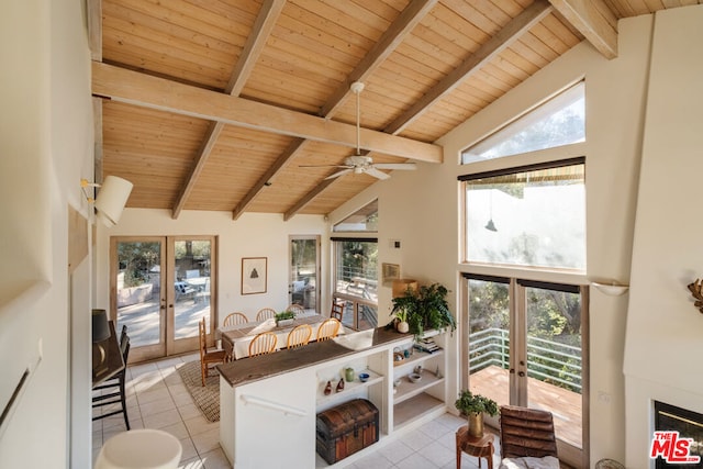 tiled living room with plenty of natural light, wood ceiling, beam ceiling, and french doors