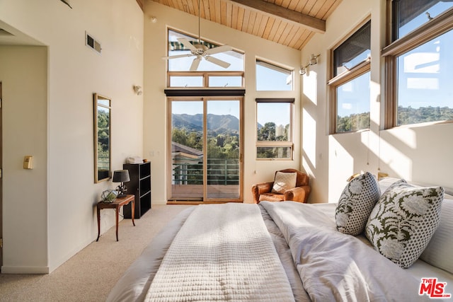 carpeted bedroom featuring multiple windows, a mountain view, access to outside, and wood ceiling