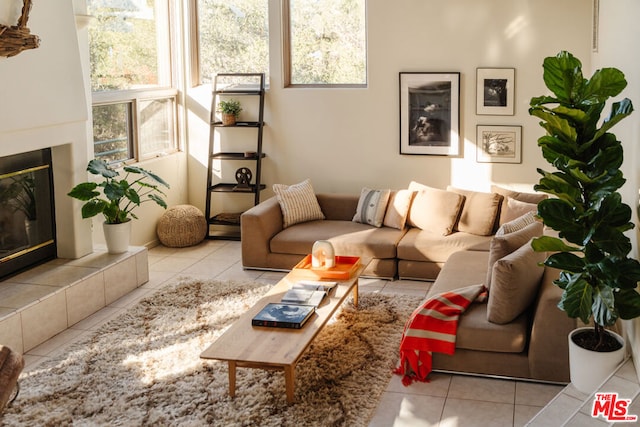 tiled living room featuring a tile fireplace