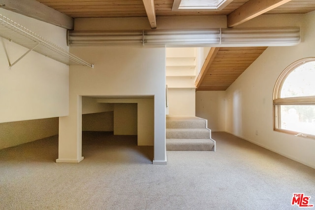 interior space with wood ceiling, carpet floors, and beamed ceiling