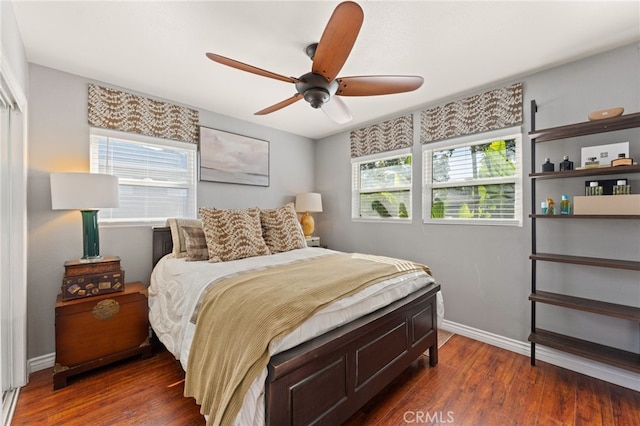 bedroom with dark wood-type flooring and ceiling fan