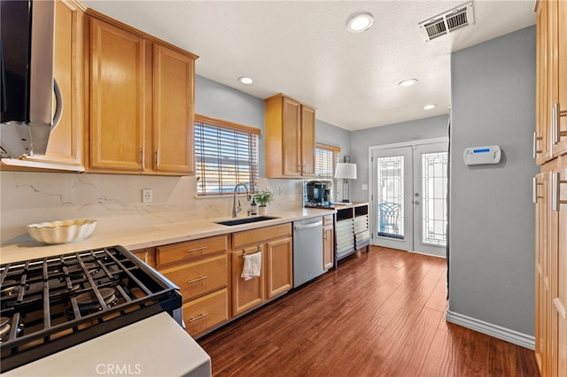 kitchen featuring french doors, stainless steel appliances, dark hardwood / wood-style flooring, and sink