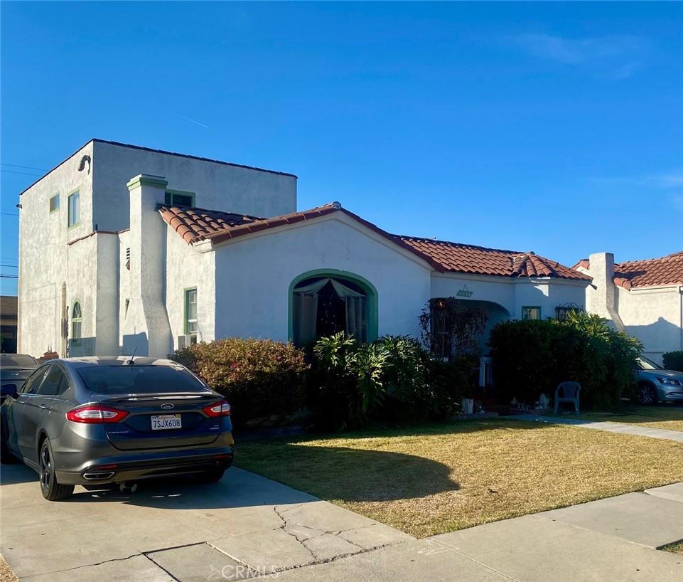 mediterranean / spanish house featuring a front yard