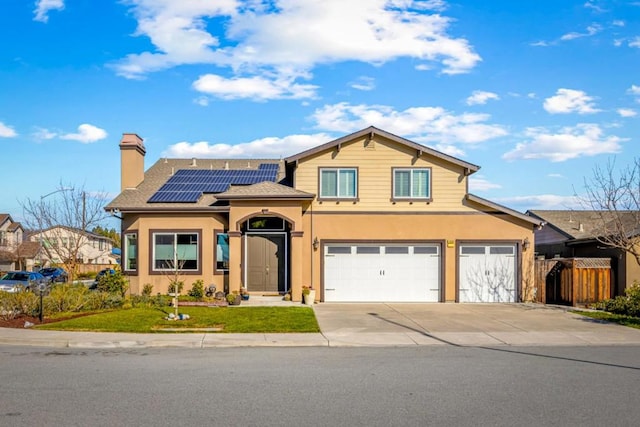 view of front of home featuring a garage and solar panels