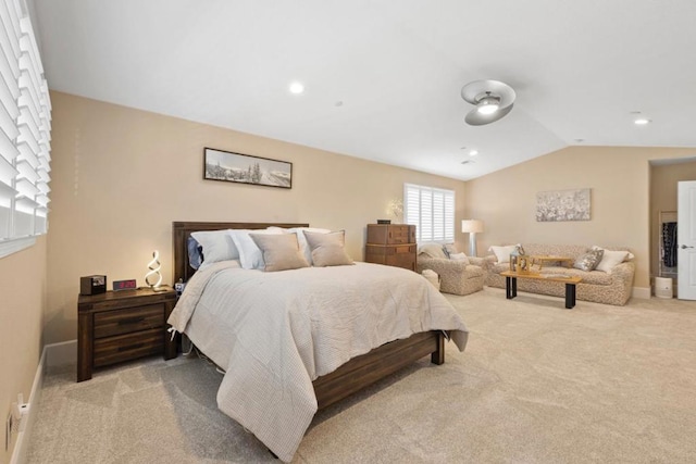 bedroom with vaulted ceiling and light carpet