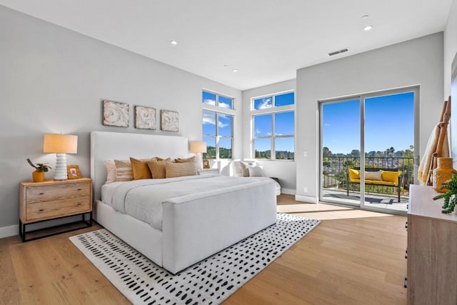 bedroom featuring access to exterior and light hardwood / wood-style flooring