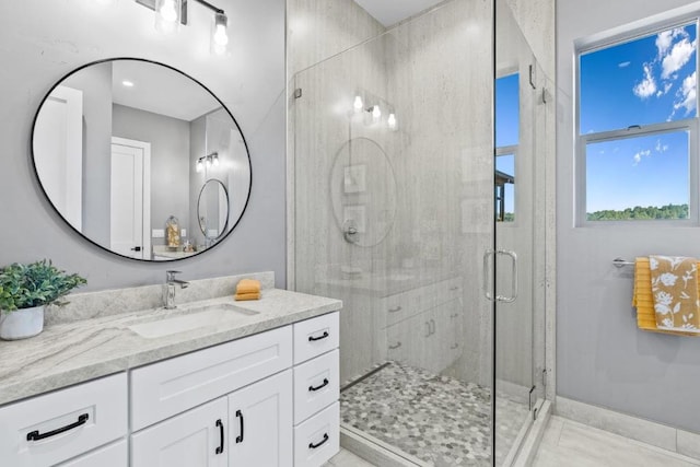 bathroom featuring vanity and a shower with shower door