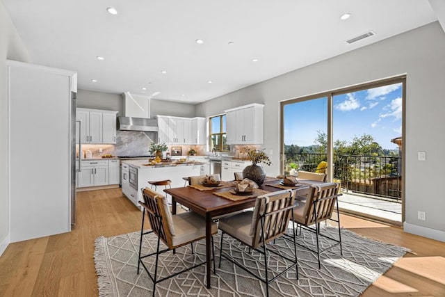 dining area with light hardwood / wood-style floors