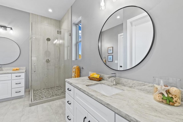 bathroom with vanity, an enclosed shower, and tile patterned flooring