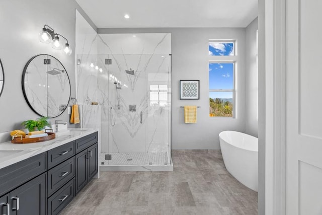 bathroom with vanity and separate shower and tub