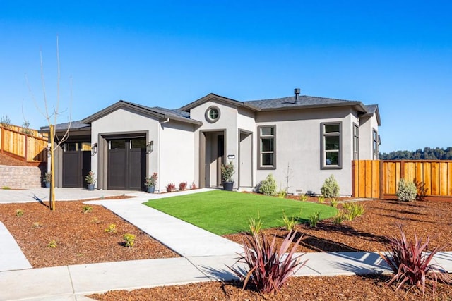 view of front of house with a garage and a front lawn