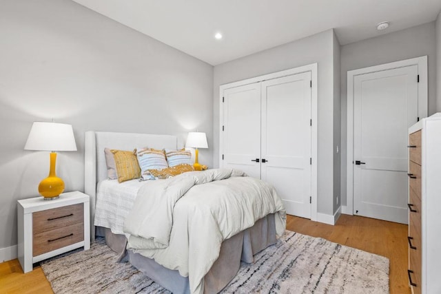 bedroom featuring light hardwood / wood-style floors and a closet