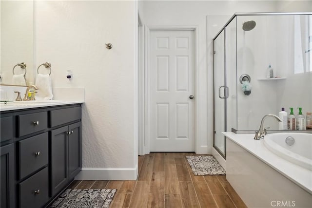 bathroom featuring independent shower and bath and vanity